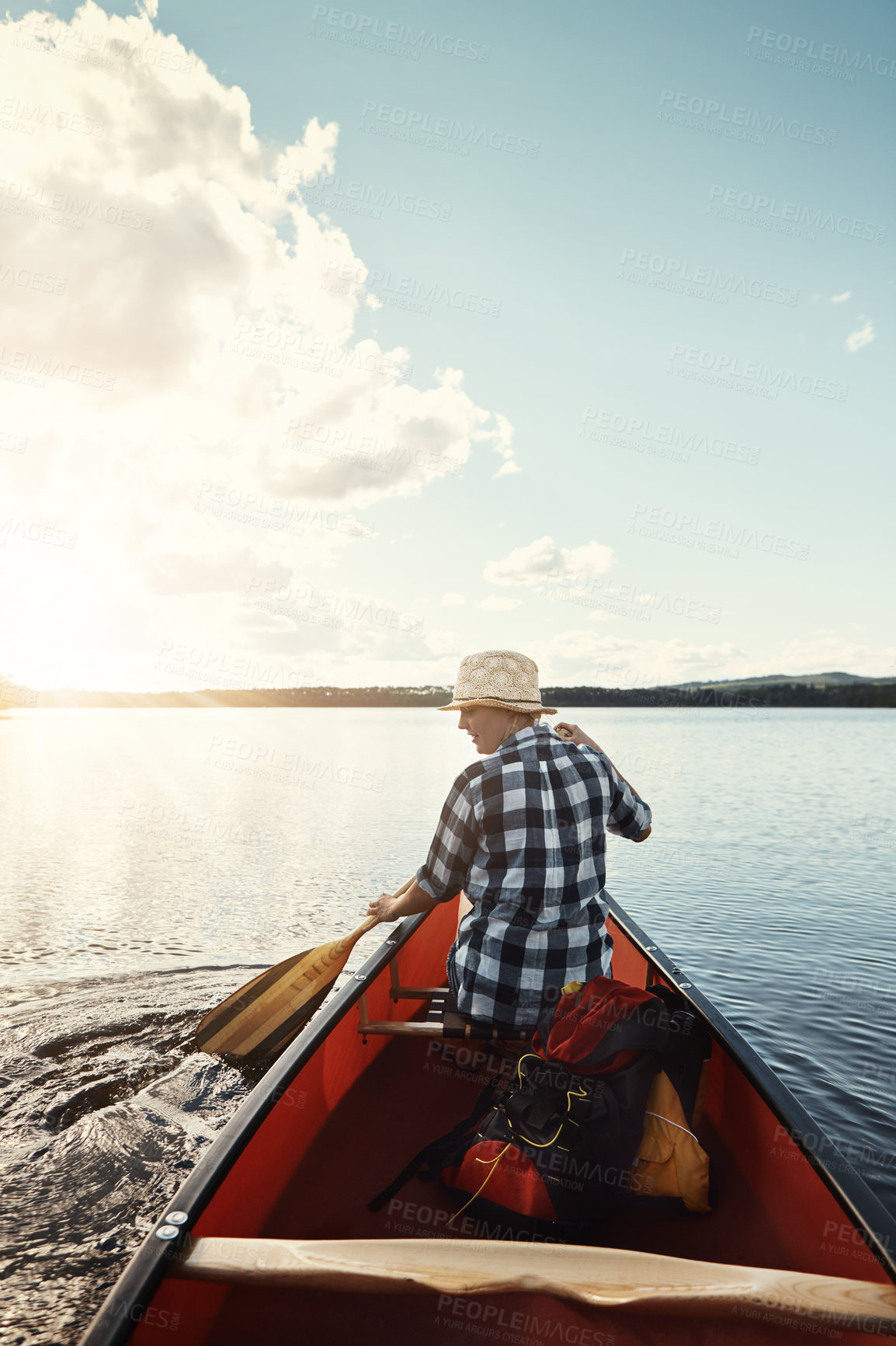 Buy stock photo Shot of an attractive young woman spending a day kayaking on the lake