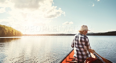 Buy stock photo Shot of an attractive young woman spending a day kayaking on the lake