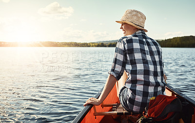 Buy stock photo Shot of an attractive young woman spending a day kayaking on the lake