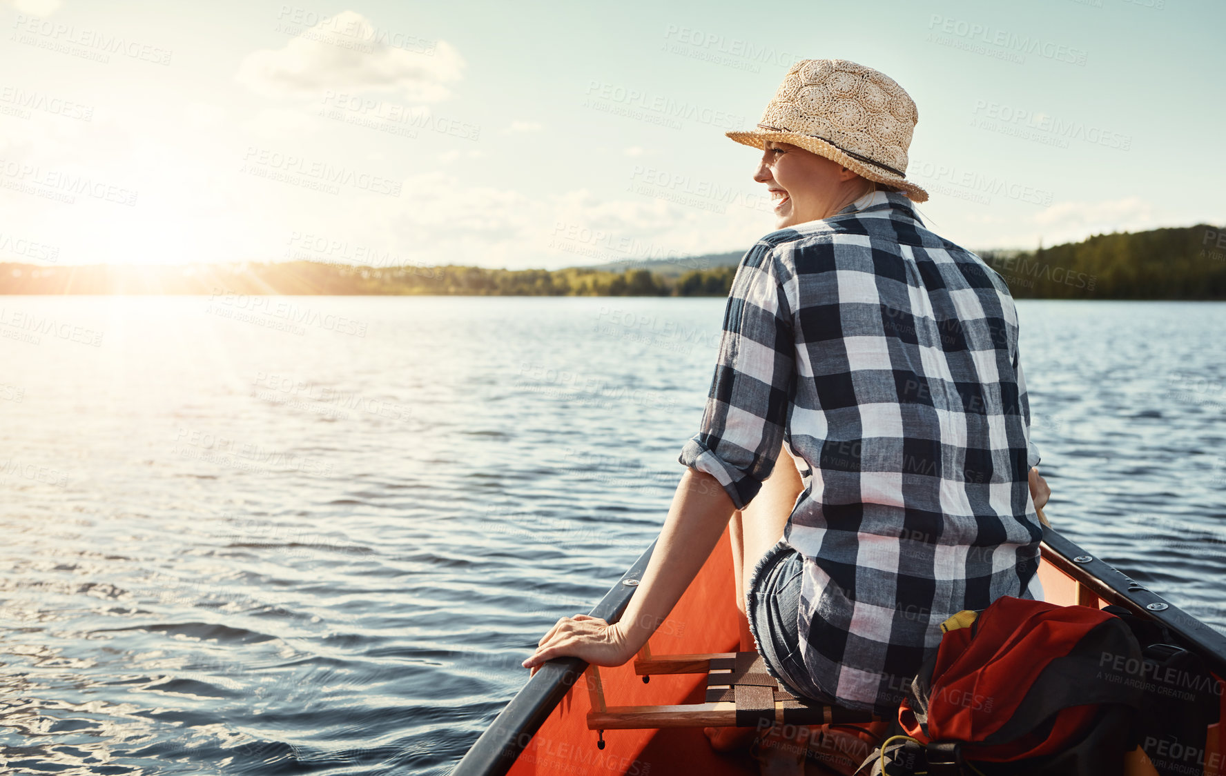 Buy stock photo Shot of an attractive young woman spending a day kayaking on the lake