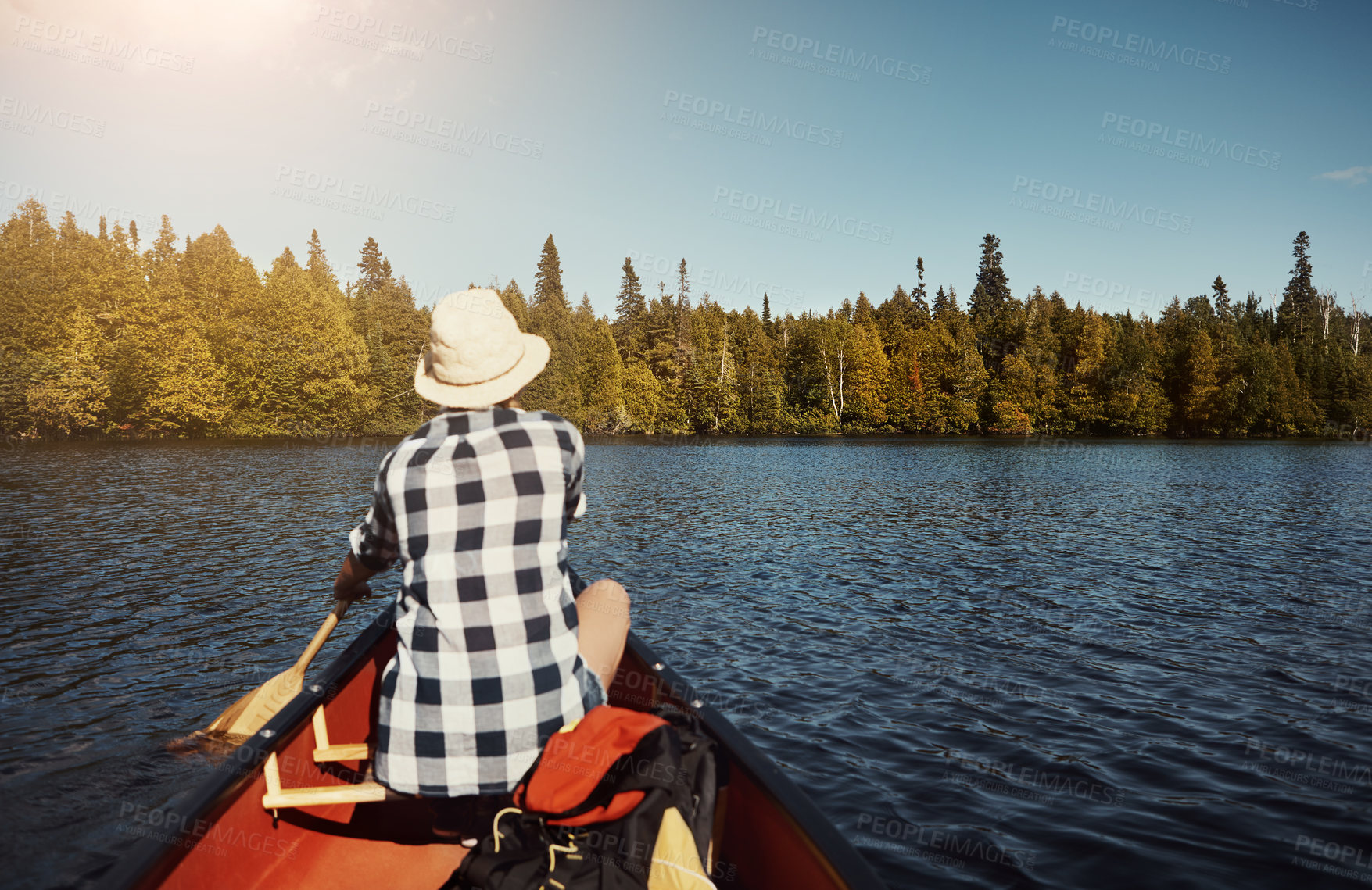 Buy stock photo Shot of an attractive young woman spending a day kayaking on the lake