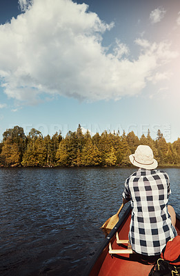 Buy stock photo Shot of an attractive young woman spending a day kayaking on the lake