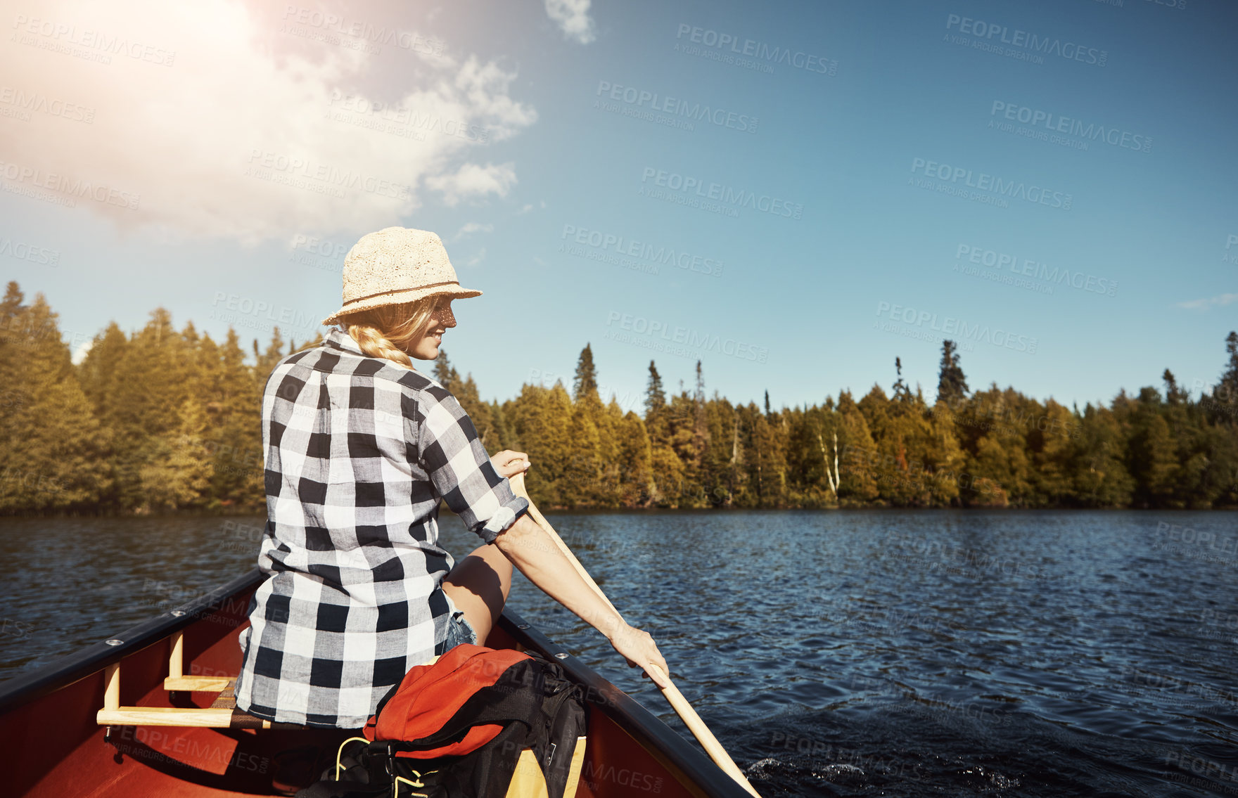 Buy stock photo Shot of an attractive young woman spending a day kayaking on the lake