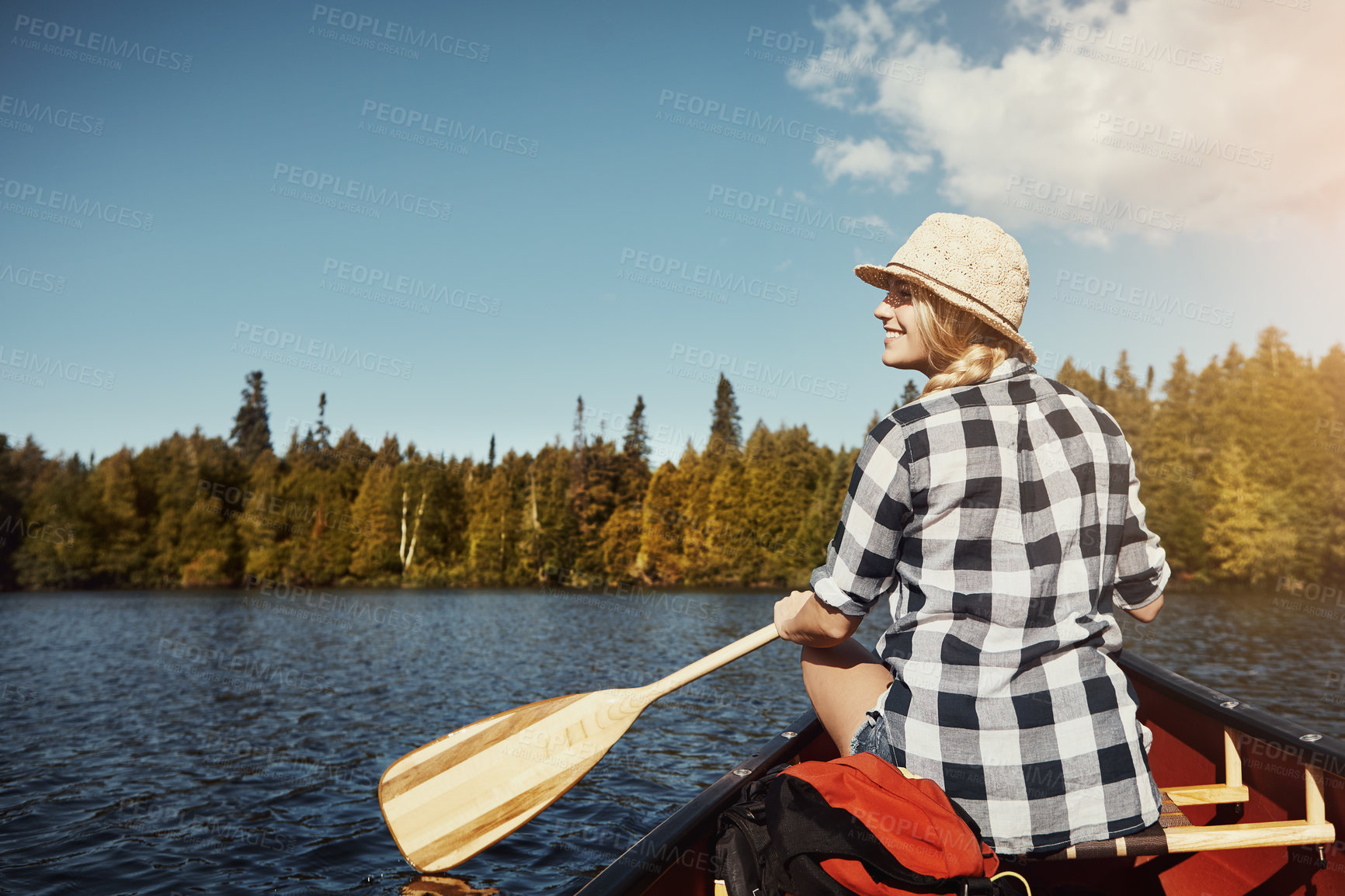 Buy stock photo Shot of an attractive young woman spending a day kayaking on the lake