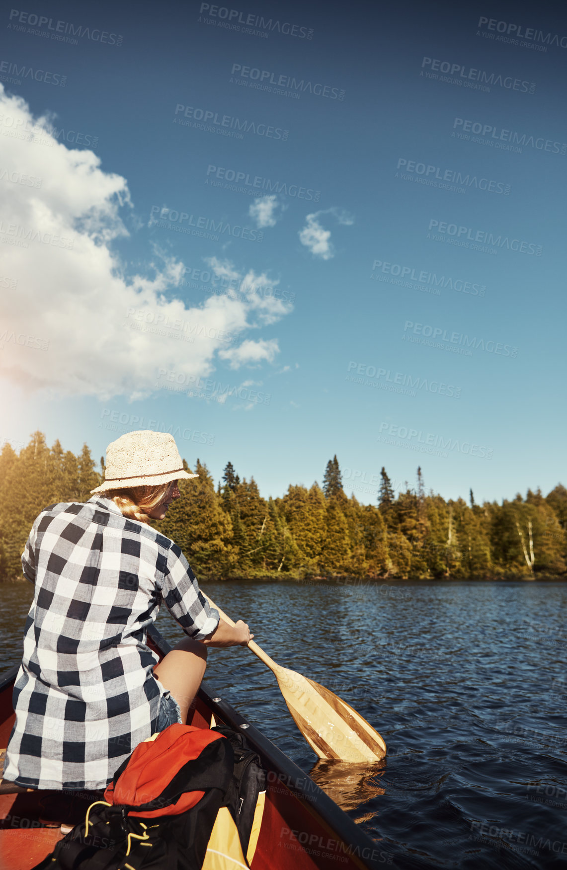 Buy stock photo Shot of an attractive young woman spending a day kayaking on the lake