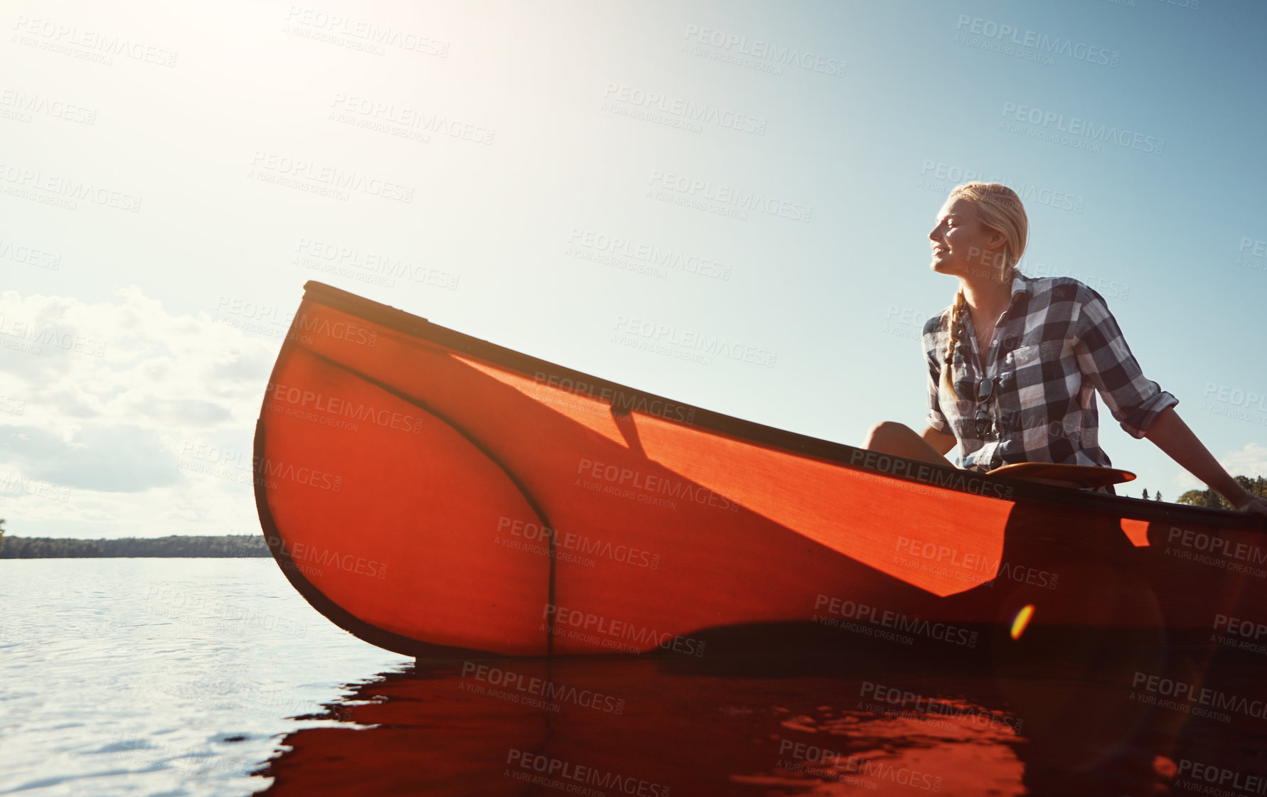 Buy stock photo Shot of an attractive young woman spending a day kayaking on the lake