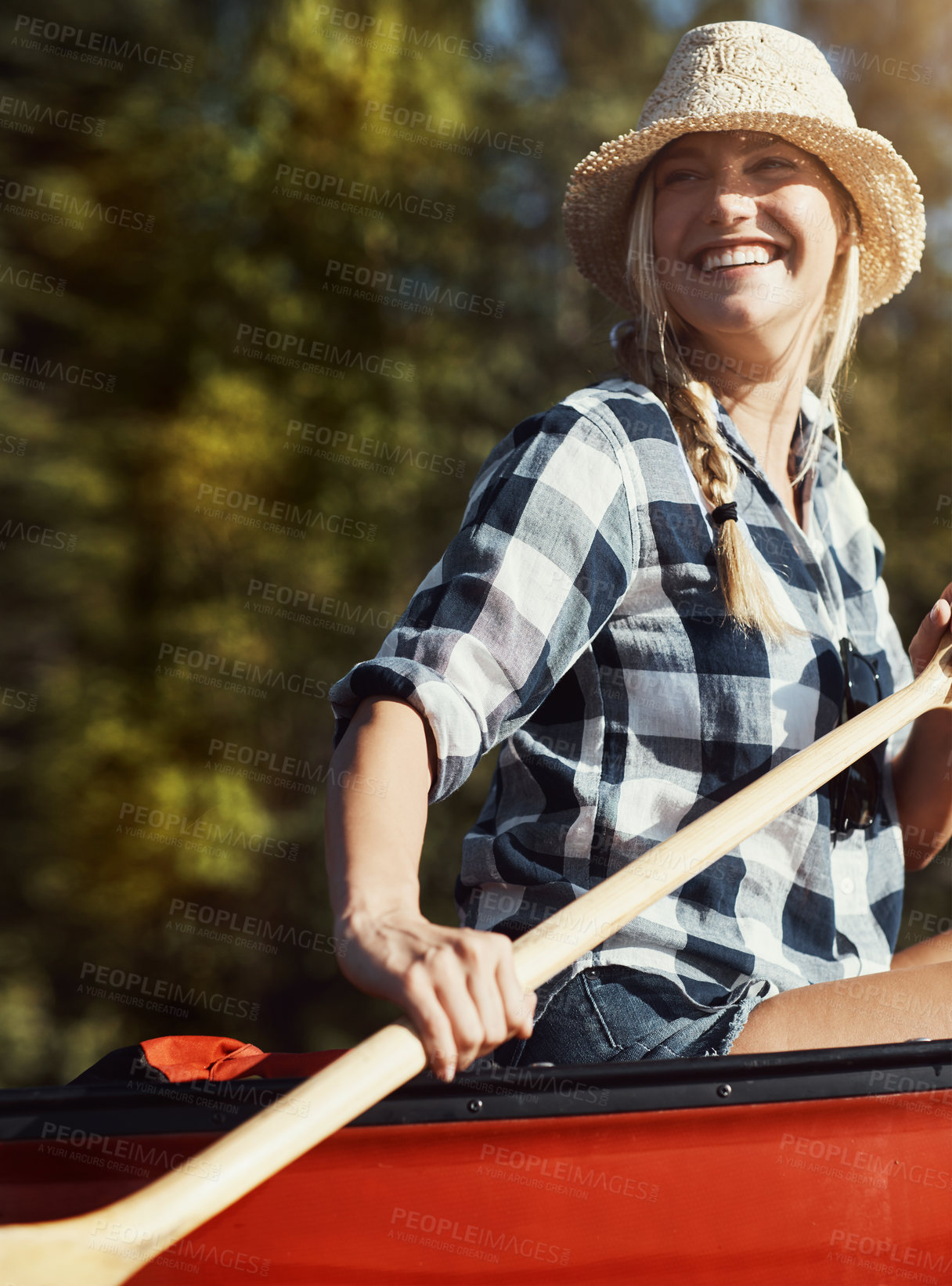 Buy stock photo Shot of an attractive young woman spending a day kayaking on the lake