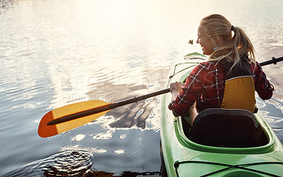 Buy stock photo Shot of an attractive young woman out for canoe ride on the lake