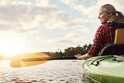 Buy stock photo Shot of an attractive young woman out for canoe ride on the lake