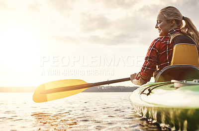 Buy stock photo Shot of an attractive young woman out for canoe ride on the lake