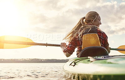 Buy stock photo Shot of an attractive young woman out for canoe ride on the lake