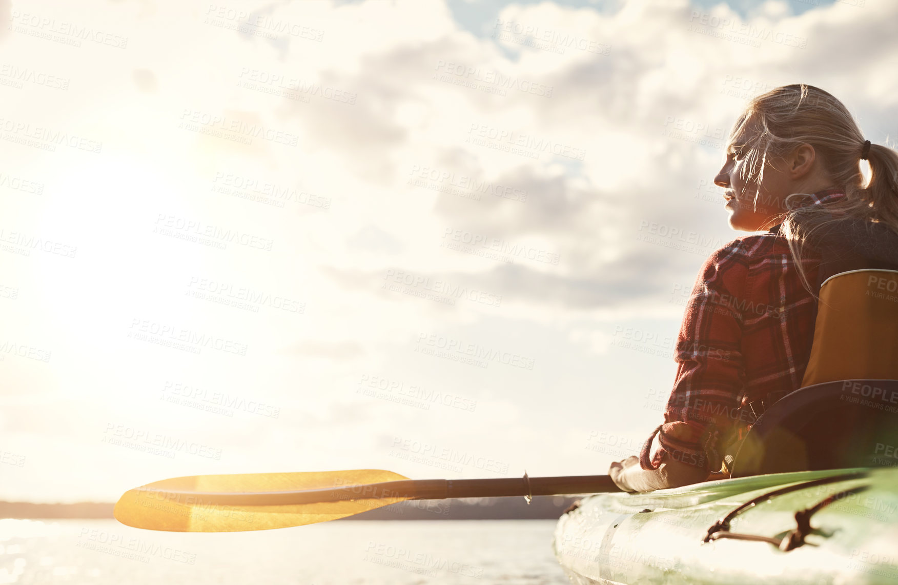 Buy stock photo Shot of an attractive young woman out for canoe ride on the lake