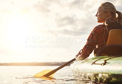 Buy stock photo Shot of an attractive young woman out for canoe ride on the lake