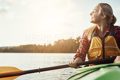 Buy stock photo Shot of an attractive young woman out for canoe ride on the lake