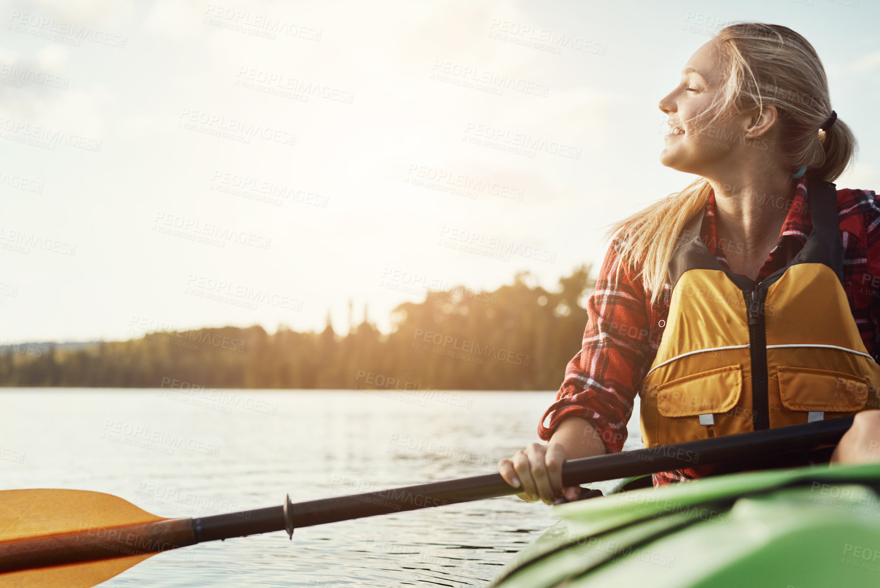 Buy stock photo Shot of an attractive young woman out for canoe ride on the lake