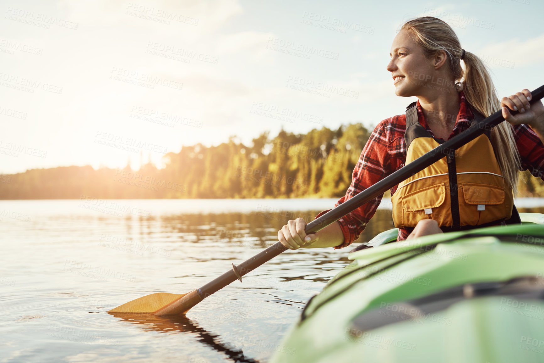 Buy stock photo Shot of an attractive young woman out for canoe ride on the lake