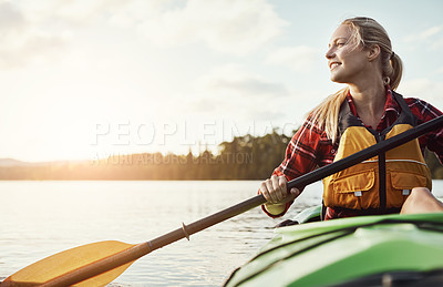 Buy stock photo Shot of an attractive young woman out for canoe ride on the lake