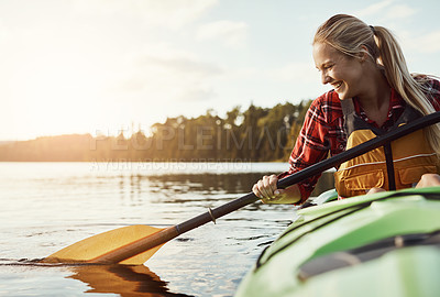 Buy stock photo Shot of an attractive young woman out for canoe ride on the lake