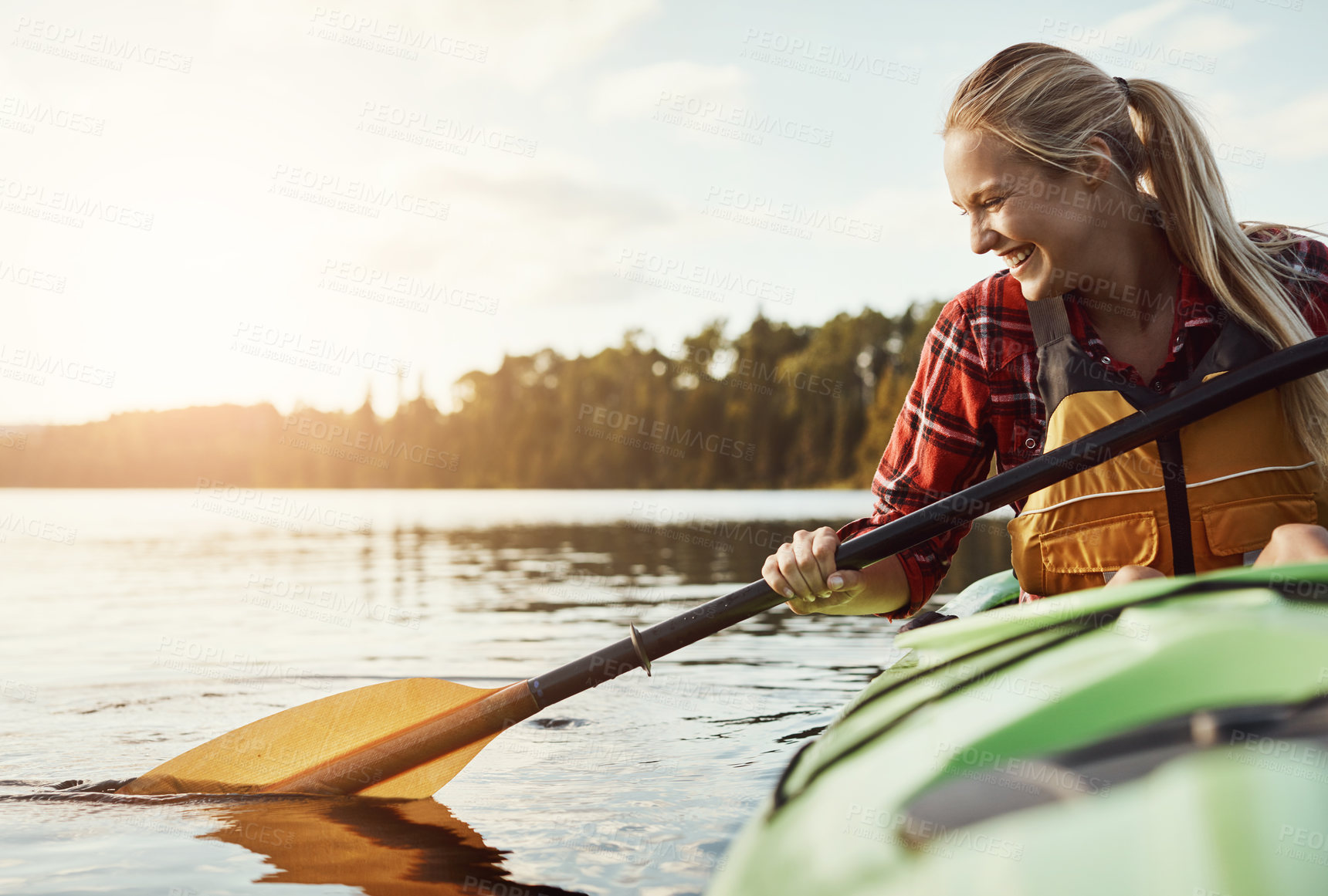 Buy stock photo Shot of an attractive young woman out for canoe ride on the lake