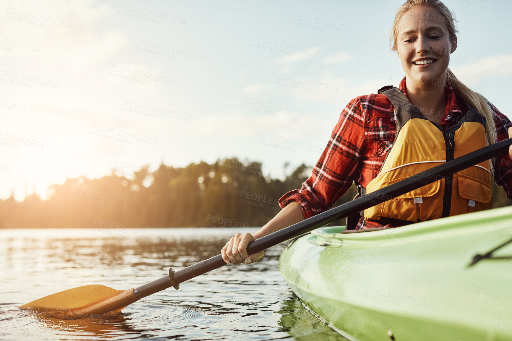 Buy stock photo Shot of an attractive young woman out for canoe ride on the lake