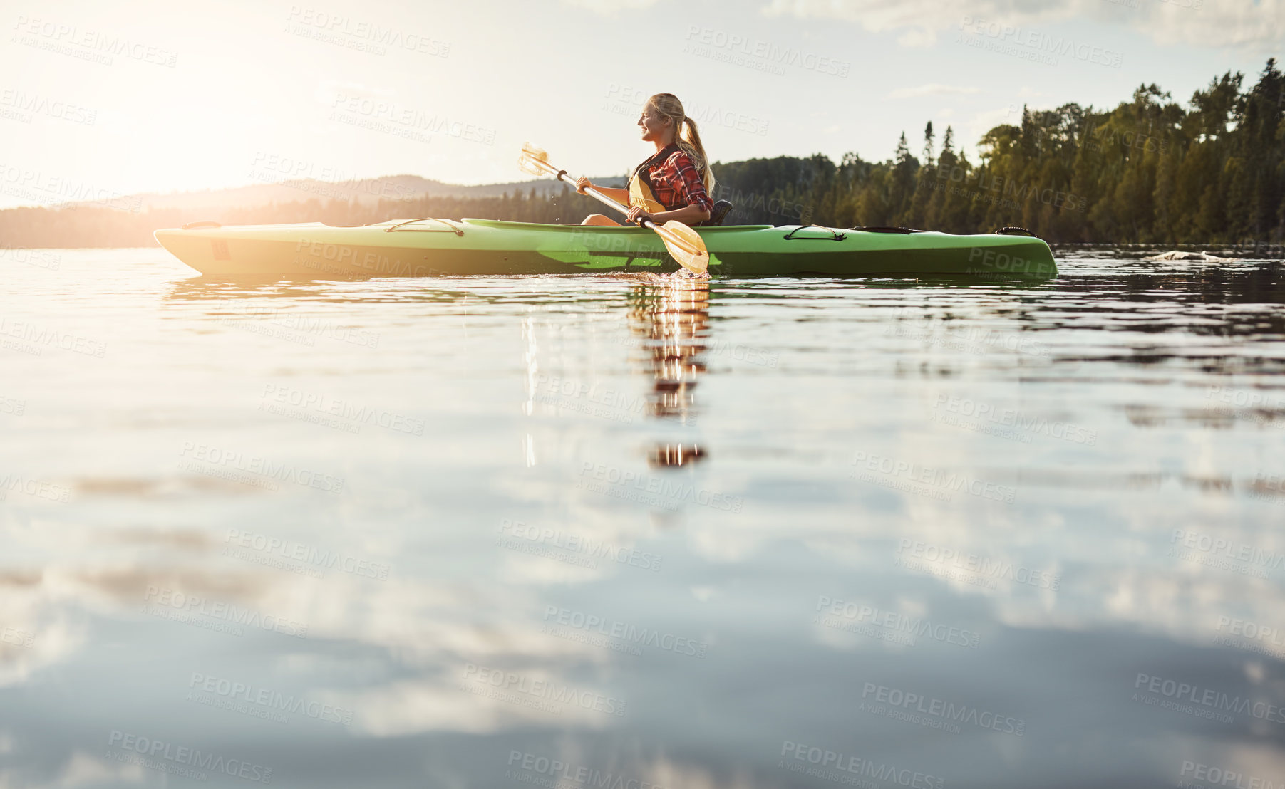 Buy stock photo Shot of an attractive young woman out for canoe ride on the lake