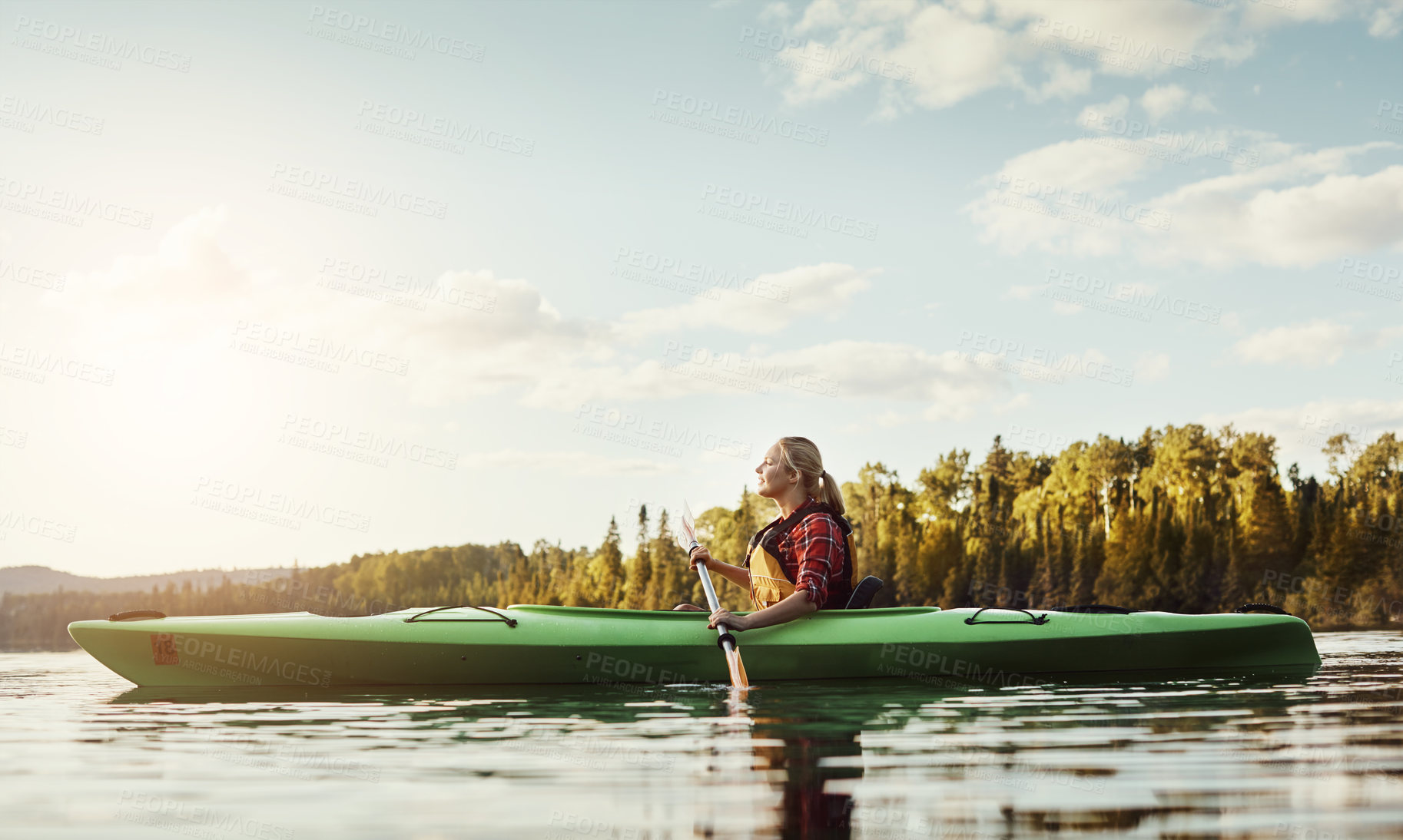 Buy stock photo Shot of an attractive young woman out for canoe ride on the lake