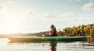 Buy stock photo Shot of an attractive young woman out for canoe ride on the lake