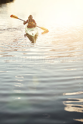 Buy stock photo Shot of an attractive young woman out for canoe ride on the lake