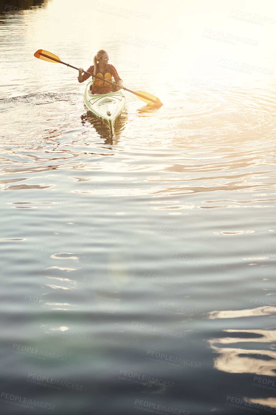 Buy stock photo Shot of an attractive young woman out for canoe ride on the lake