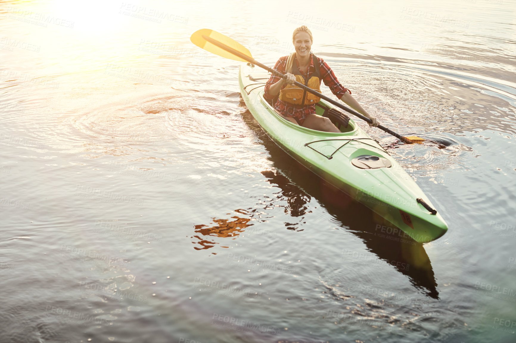 Buy stock photo Shot of an attractive young woman out for canoe ride on the lake