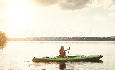 Buy stock photo Shot of an attractive young woman out for canoe ride on the lake