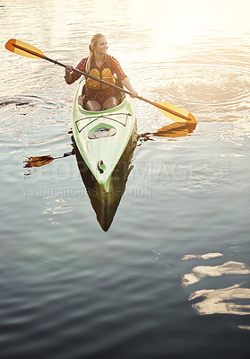 Buy stock photo Shot of an attractive young woman out for canoe ride on the lake