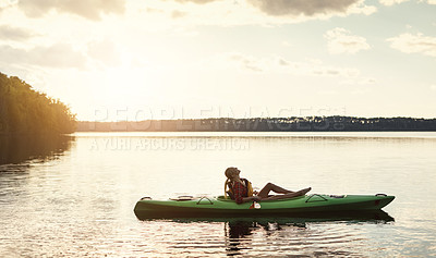 Buy stock photo Shot of an attractive young woman out for canoe ride on the lake