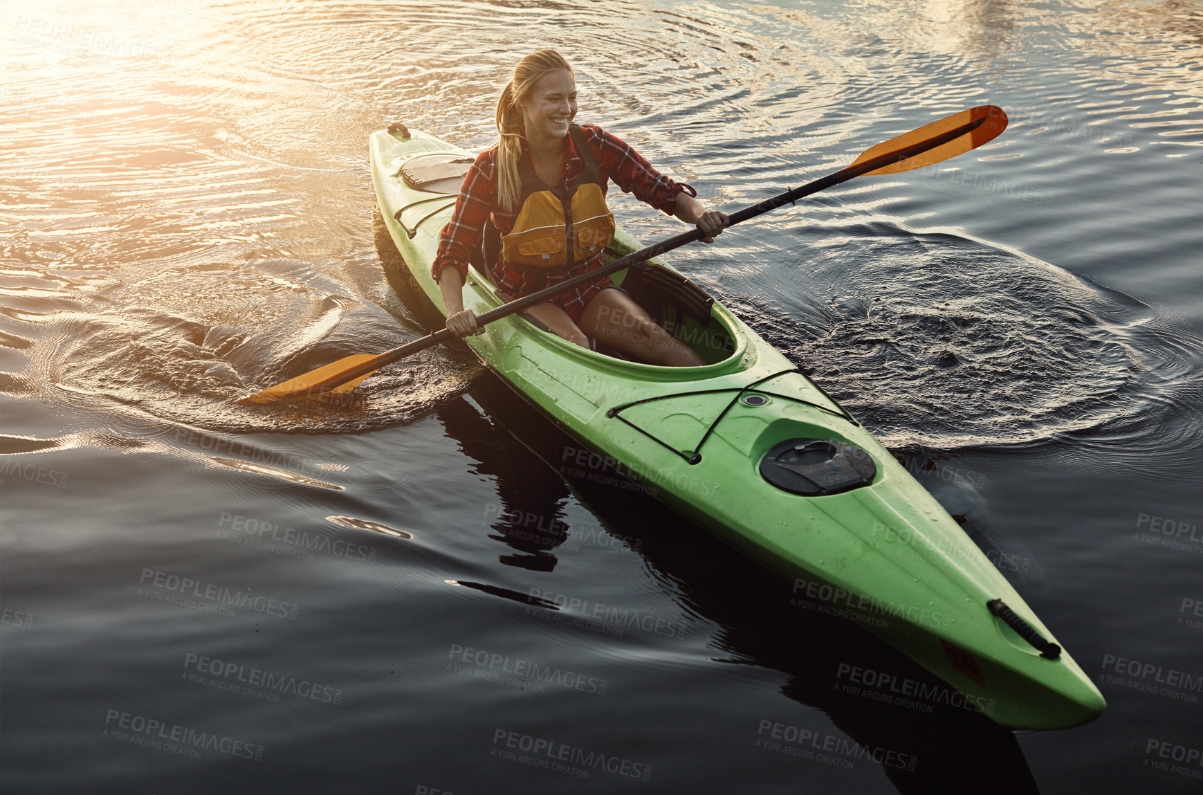 Buy stock photo Shot of an attractive young woman out for canoe ride on the lake