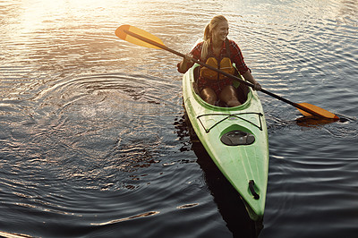 Buy stock photo Shot of an attractive young woman out for canoe ride on the lake