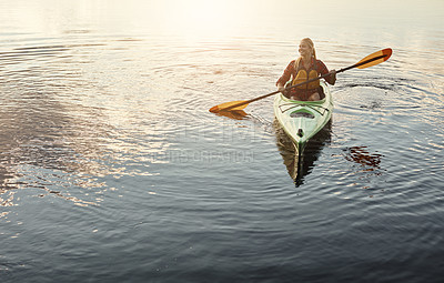 Buy stock photo Shot of an attractive young woman out for canoe ride on the lake