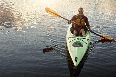 Buy stock photo Shot of an attractive young woman out for canoe ride on the lake