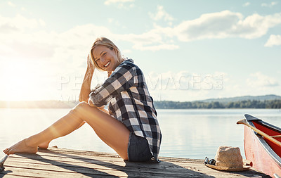 Buy stock photo Woman, portrait and sunset outdoor for relax, holiday and travel by lake with happiness or peace. Female person, smile and face in nature for vacation, summer and wellness by pond with mindfulness