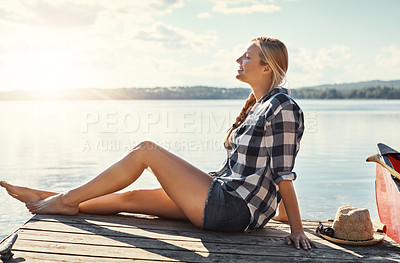 Buy stock photo Woman, relax and sunset outdoor for peace, holiday and travel by lake with happiness or freedom. Female person, smile and blue sky in nature for vacation, summer and wellness by pond with mindfulness