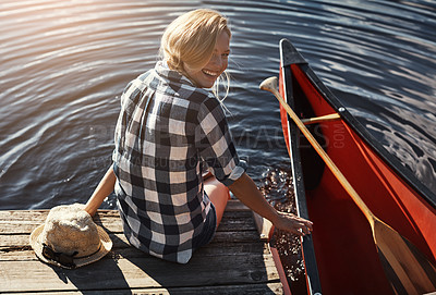 Buy stock photo High angle shot of an attractive young woman spending a day relaxing by the lake