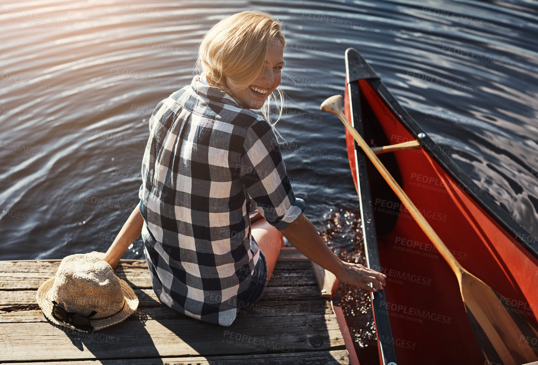 Buy stock photo High angle shot of an attractive young woman spending a day relaxing by the lake