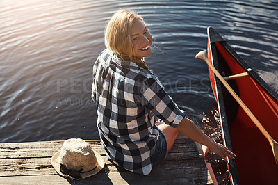 Buy stock photo High angle shot of an attractive young woman spending a day relaxing by the lake