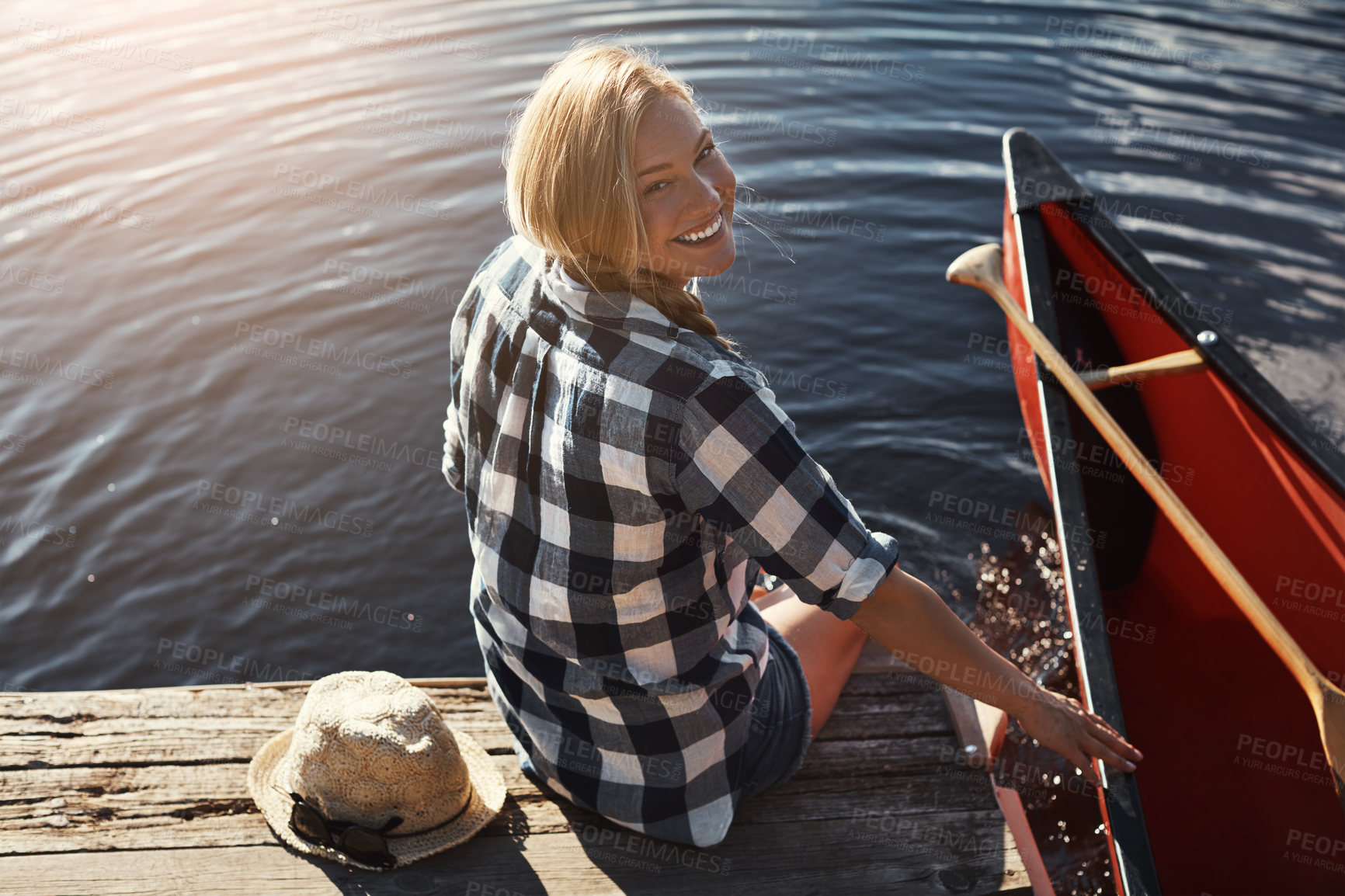 Buy stock photo High angle shot of an attractive young woman spending a day relaxing by the lake