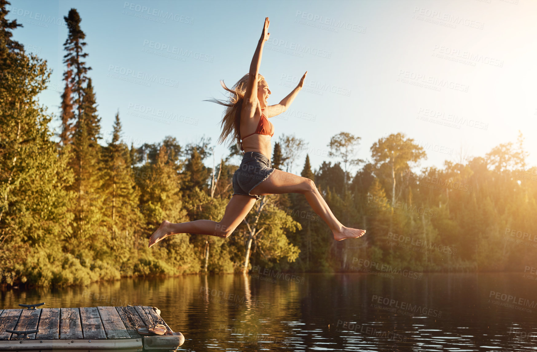 Buy stock photo Jump, woman and lake in nature for swim, fun and refresh in woods for travel adventure. Vacation, river or water for tourism outdoor for female person, happy and holiday in Germany forest in swimsuit