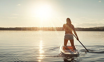 Buy stock photo Lake, sunset and woman on paddle board for relax, water sports and vacation on river for tourism. Sunset, back and holiday in Germany for female person, swimsuit and travel fitness or adventure