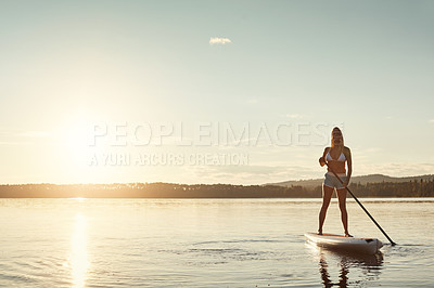 Buy stock photo River, sunset and woman on paddle board with sunshine, water sport and vacation on lake for tourism. Exercise, summer or holiday in Germany for female person, swimsuit or travel fitness for adventure