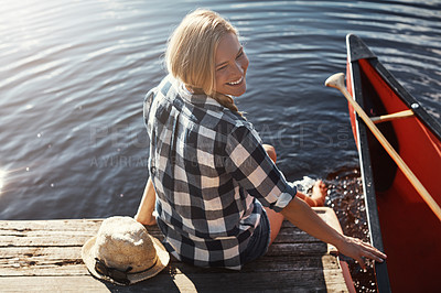 Buy stock photo High angle shot of an attractive young woman spending a day relaxing by the lake