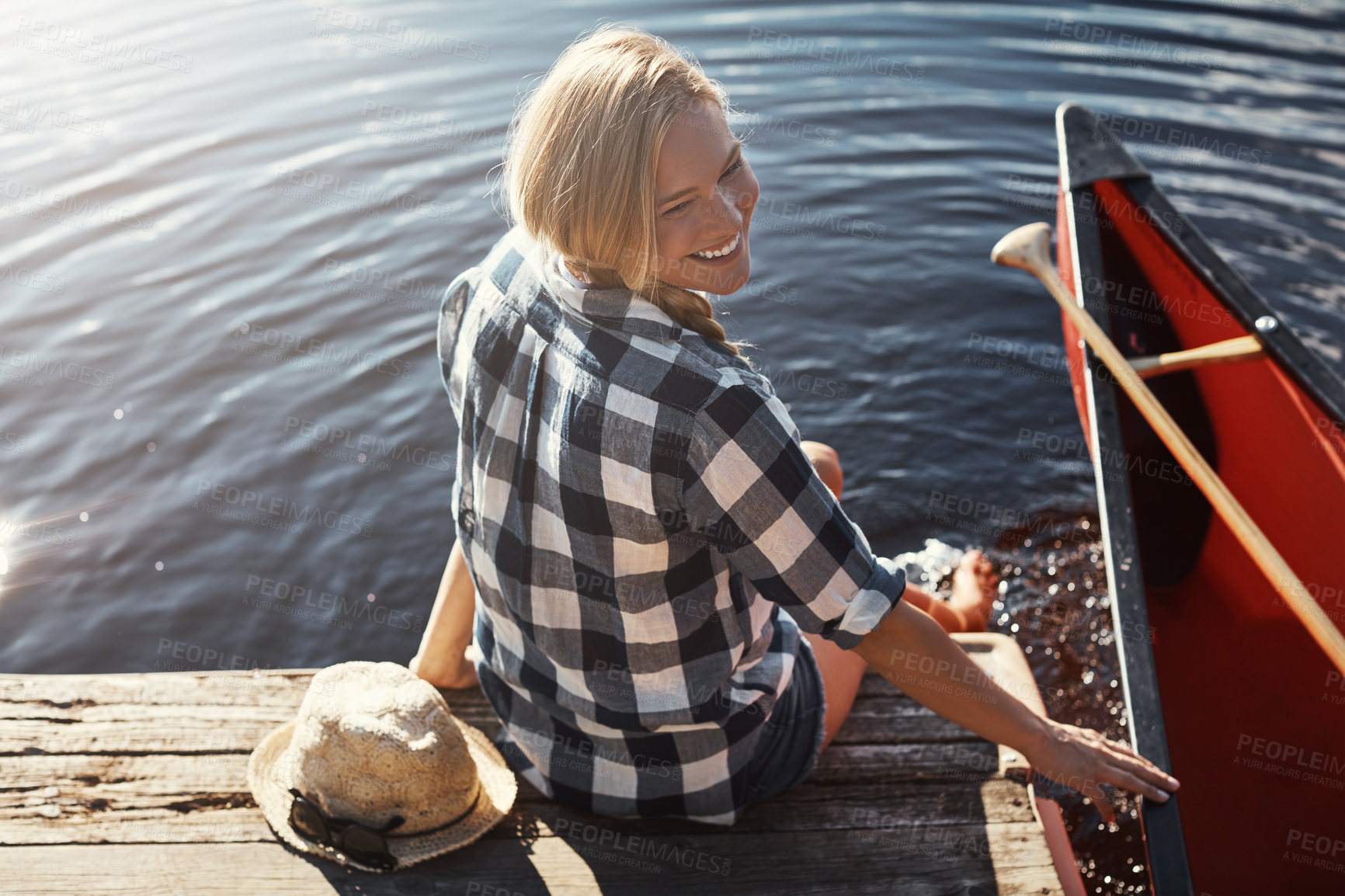 Buy stock photo High angle shot of an attractive young woman spending a day relaxing by the lake