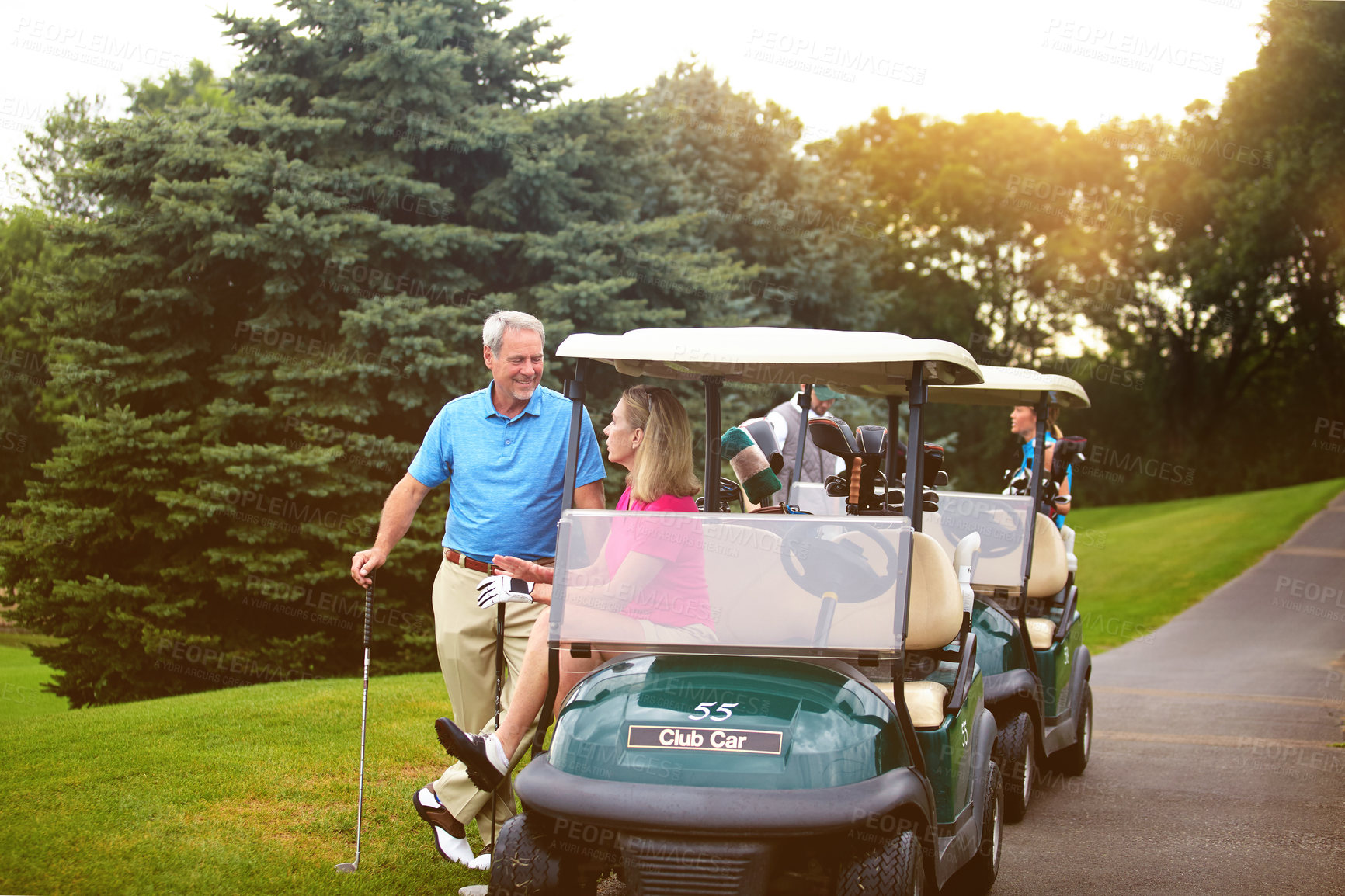 Buy stock photo Shot of an affectionate mature couple spending a day on the golf course