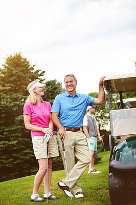 Buy stock photo Shot of an affectionate mature couple spending a day on the golf course